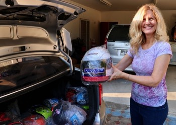  Kelly displaying a child's motorcycle helmet purchased for a Koala Outreach 